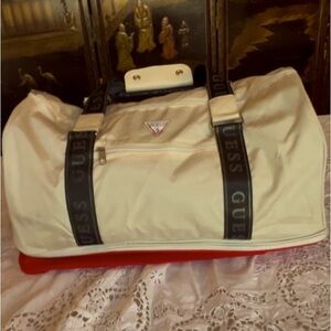Duffle by Guess white/cream colored tote with extra red storage on the bottom.